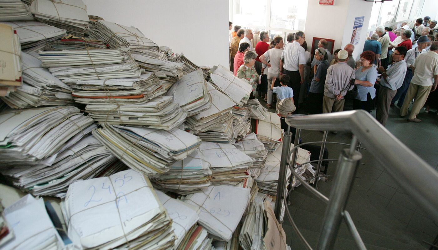 helping the eldery Eldery in the regional pension authority building with a huge amoung of dossier containing their documents for pension.